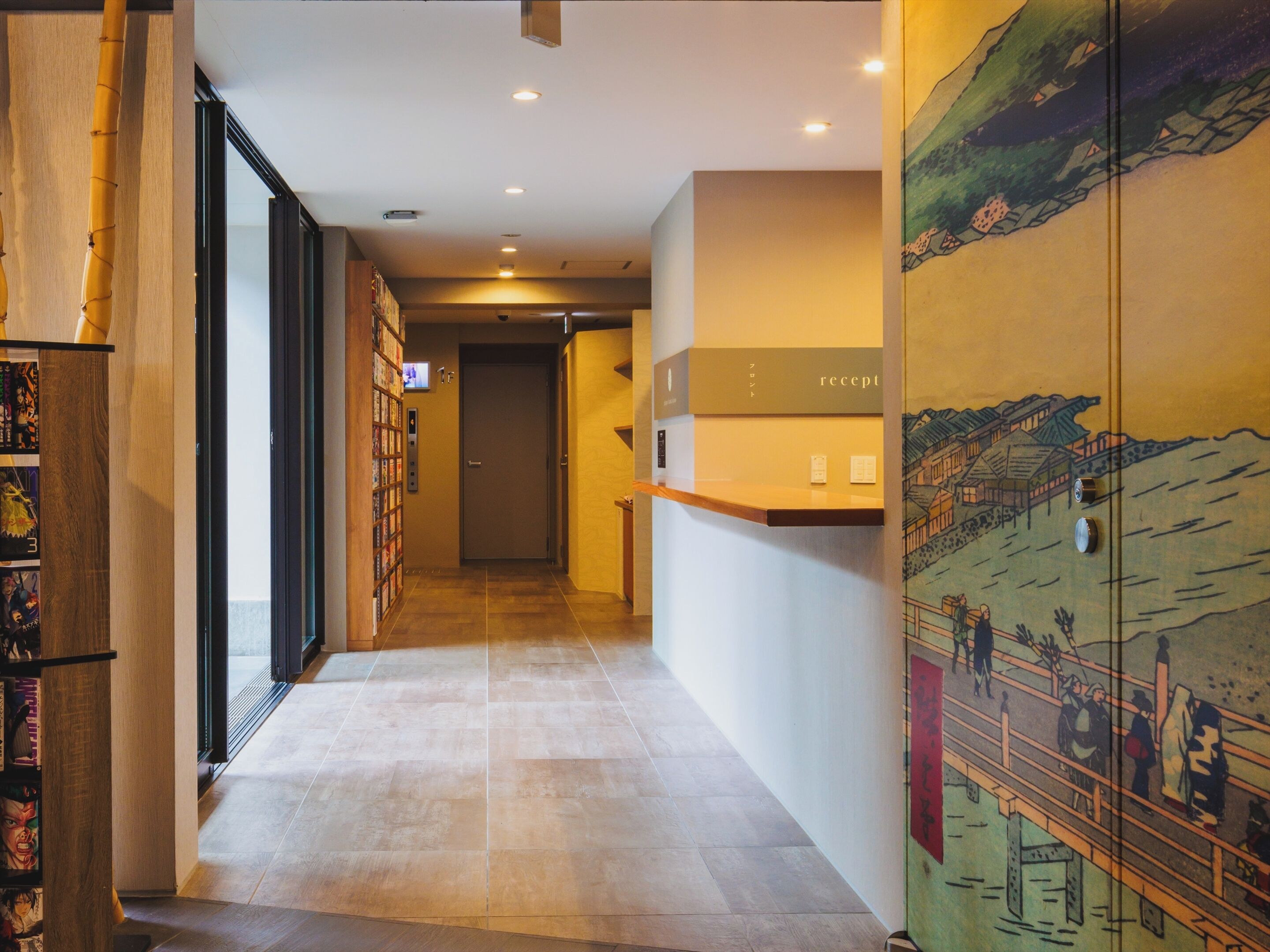 A hotel reception area with a reception desk, a wall-mounted television, and a reception sign.