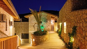 A stone building with a wooden deck and a circular stone pattern in the center.