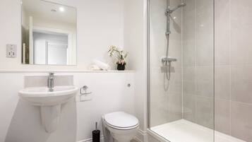 Shower, hair dryer, towels, shampoo
