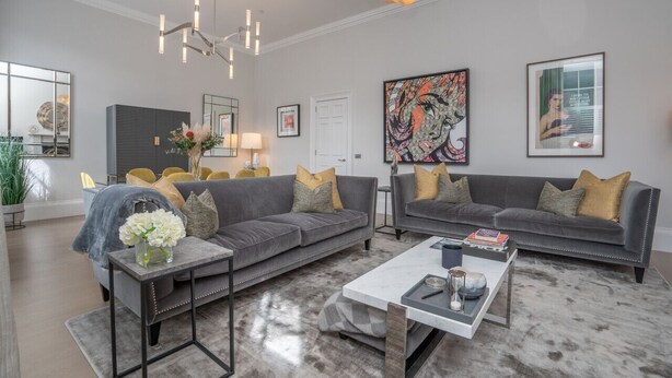 A modern living room with grey sofas, a coffee table, and a chandelier. - Georgian Gem in the New Town (Edinburgh)