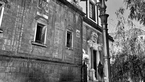A historic building with a brick facade, ornate street lamps, and a staircase leading to an entrance. - La Nova Bed and Museum (Naples)