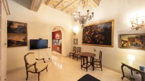 A spacious living room with a chandelier, a flat-screen TV, and artwork on the walls. - Boccaccio 22 - 4 (Roma)