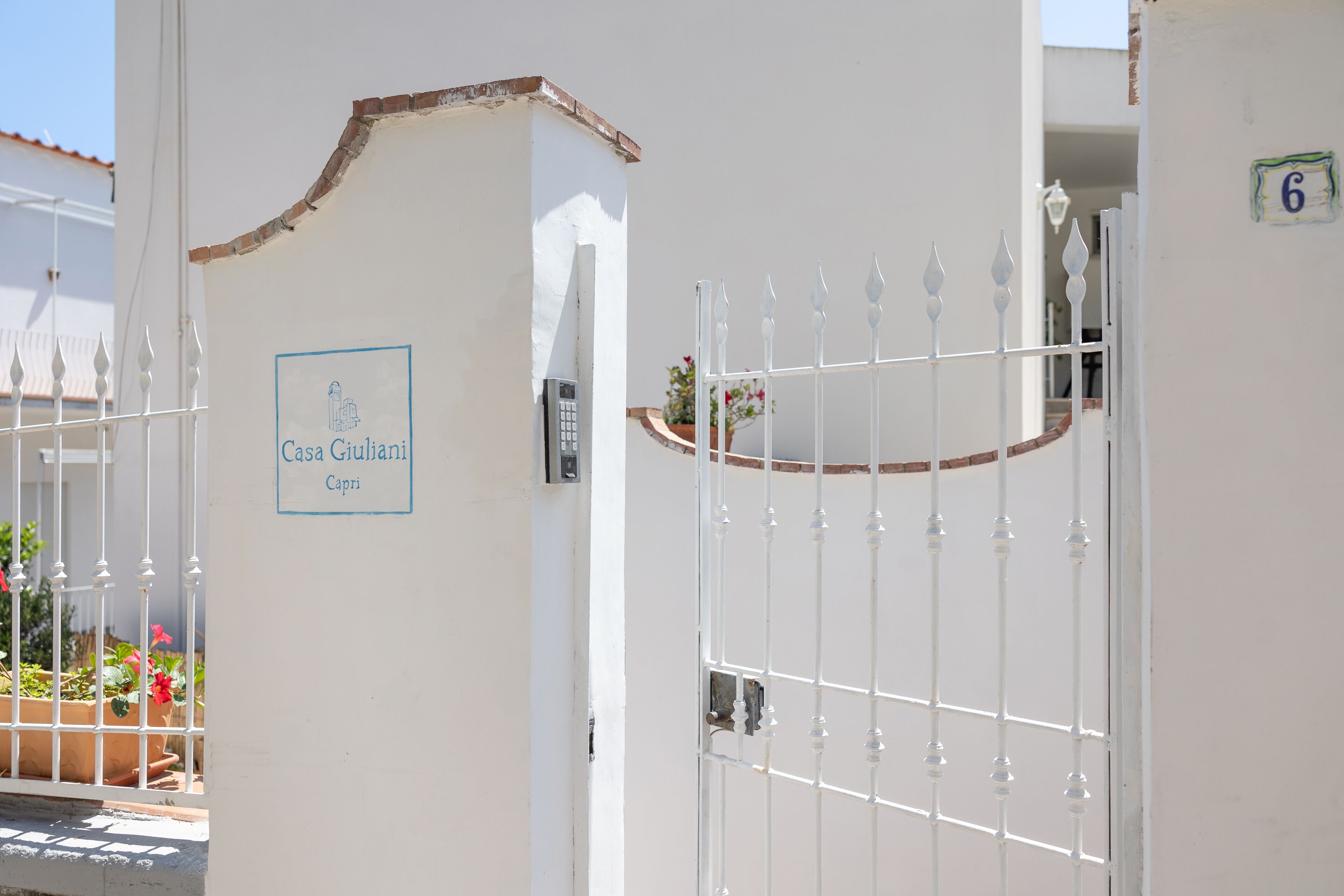 A gated entrance with a sign reading "Casa Giuliani Capri".