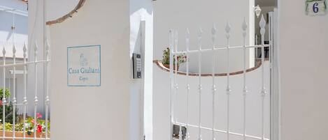 A gated entrance with a sign reading "Casa Giuliani Capri".