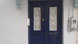 A dark blue door with decorative glass panels and a small step leading up to it. - Blue Mansion, Plomari, Lesvos Island, Greece (Plomari)