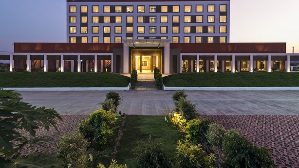 A modern hotel with a symmetrical facade, multiple windows, and a central entrance. - Pride Elite Phaltan (Phaltan)