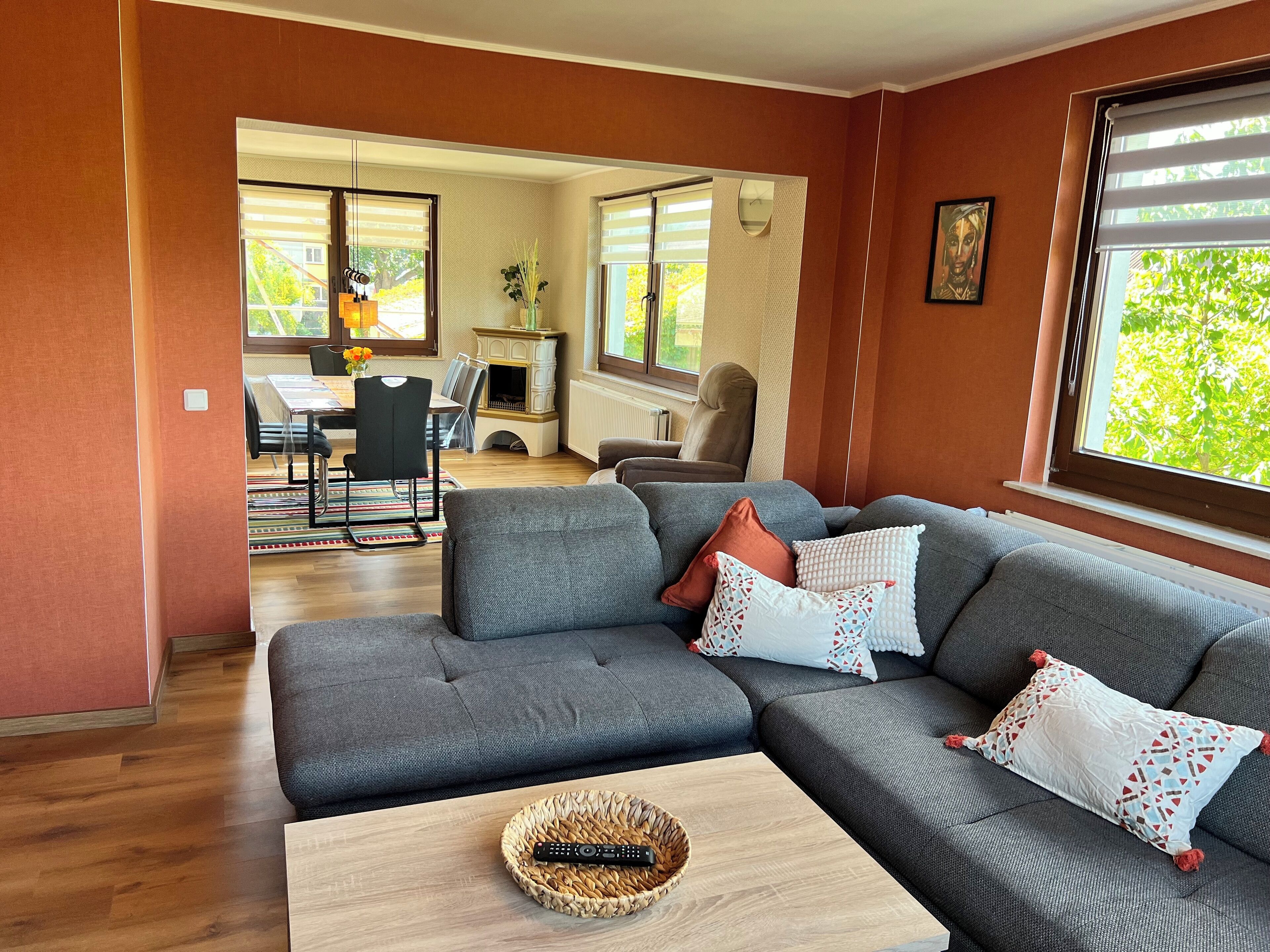 A modern living room with a grey sectional sofa, a coffee table, and a fireplace.