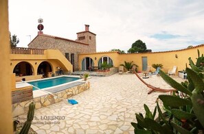 Relax by the pool surrounded by lush plants and lounge in style.