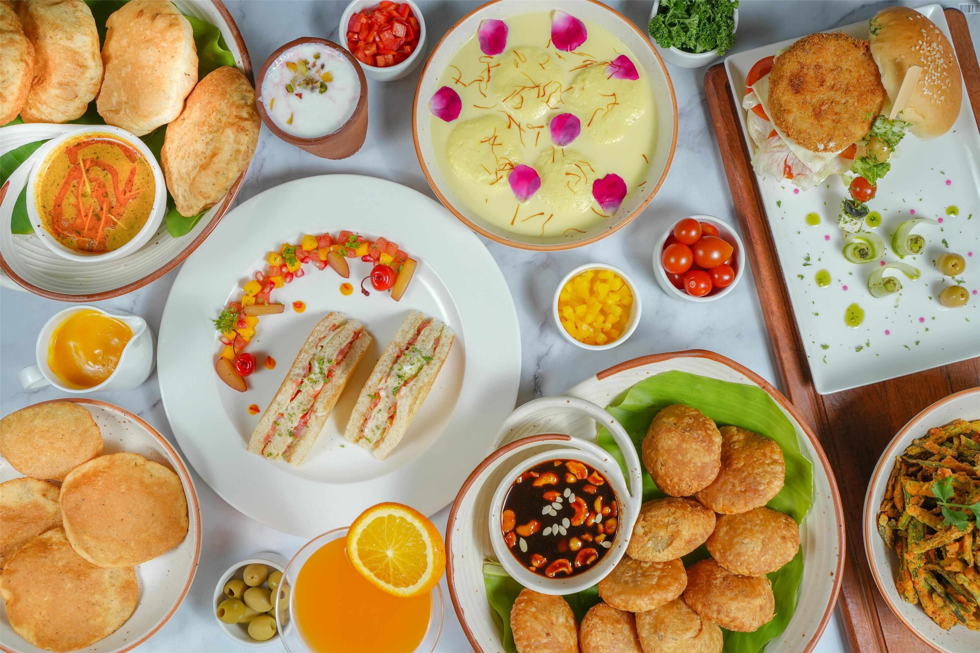 A variety of dishes including sandwiches, fried items, and a bowl of soup.