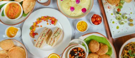 A variety of dishes including sandwiches, fried items, and a bowl of soup.