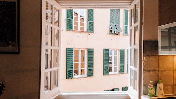 A view from a window with green shutters, a white door, and a framed picture on the wall. - The Bright Nest Aquarium - Genoa Historical Center (Genova)