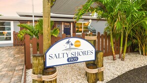 A sign for Salty Shores with a beach and palm tree theme, located at 1505. - Salty Shores Secluded Oasis (Englewood)