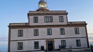 A historic building with a central dome and multiple windows, labeled "FARO DE FINISTERE." - Apto Las Dunas de Langosteira en Finisterre (finisterre)