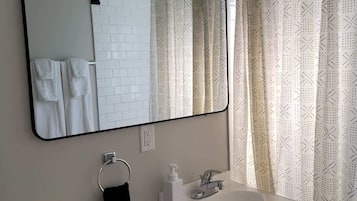 Shower, hair dryer, towels, shampoo