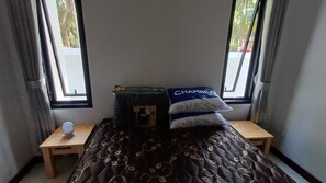 A small room with a bed, a nightstand, and a window. - Tropical Island Retreat in Baan Tai, Thailand (Ko Pha-ngan)