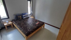 A bedroom with a bed, a nightstand, a window, and a door. - Tropical Island Retreat in Baan Tai, Thailand (Ko Pha-ngan)