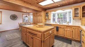 A spacious kitchen with wooden cabinets, a large island, and a skylight. - Summer Retreat|5BR Stay Near Lake, Hikes~Water Fun (Big Bear Lake)