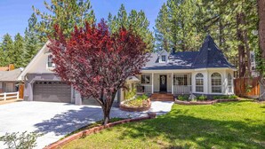 A two-story house with a covered porch, a garage, and a well-maintained lawn. - Summer Retreat|5BR Stay Near Lake, Hikes~Water Fun (Big Bear Lake)
