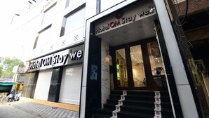 A hotel entrance with a sign reading "Hotel OM Stay We". - Hotel Om Stay Well (Indore)