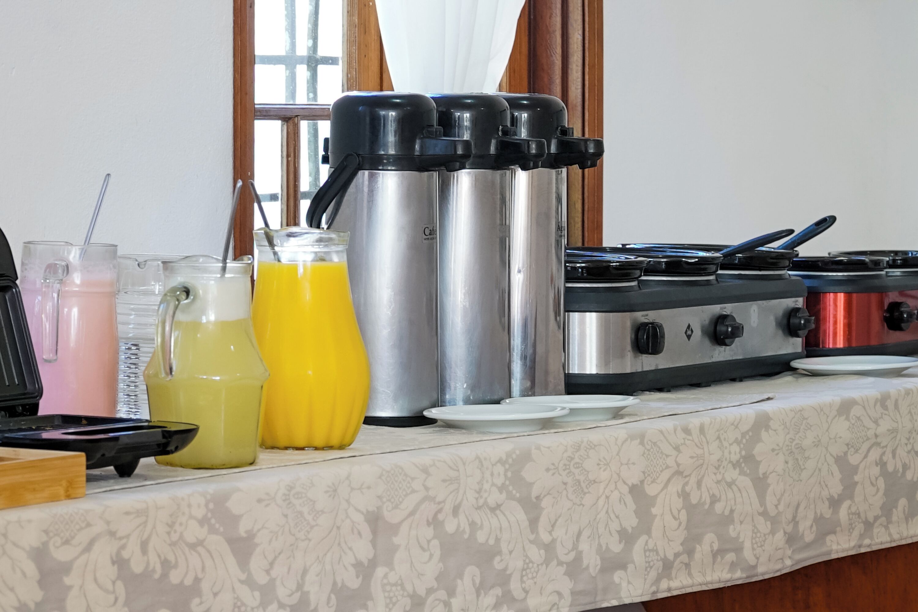 A kitchen counter with a coffee maker, a toaster, and various beverage containers.
