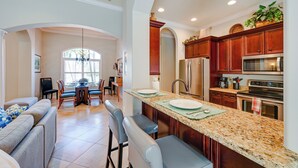 A spacious kitchen with granite countertops, stainless steel appliances, and wooden cabinets. - Marco Island Home w/ Private Pool: 3 Mi Beach! (Marco Island)