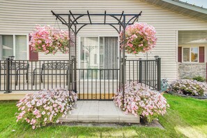A covered porch with a metal railing, a wooden bench, and a small table. - Pet-friendly Sheboygan Home: 4 Mi to Lake Michigan (Sheboygan)