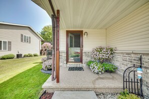 A residential house with a front porch, a door, and potted plants. - Pet-friendly Sheboygan Home: 4 Mi to Lake Michigan (Sheboygan)