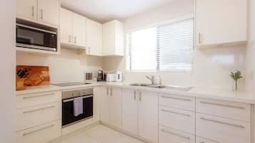 Fridge, microwave, stovetop, coffee/tea maker