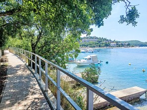 Stroll along the waterfront promenade, taking in the serene views of the sea and lush greenery.