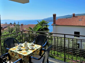 Enjoy a romantic meal on this balcony overlooking the scenic coastal view.