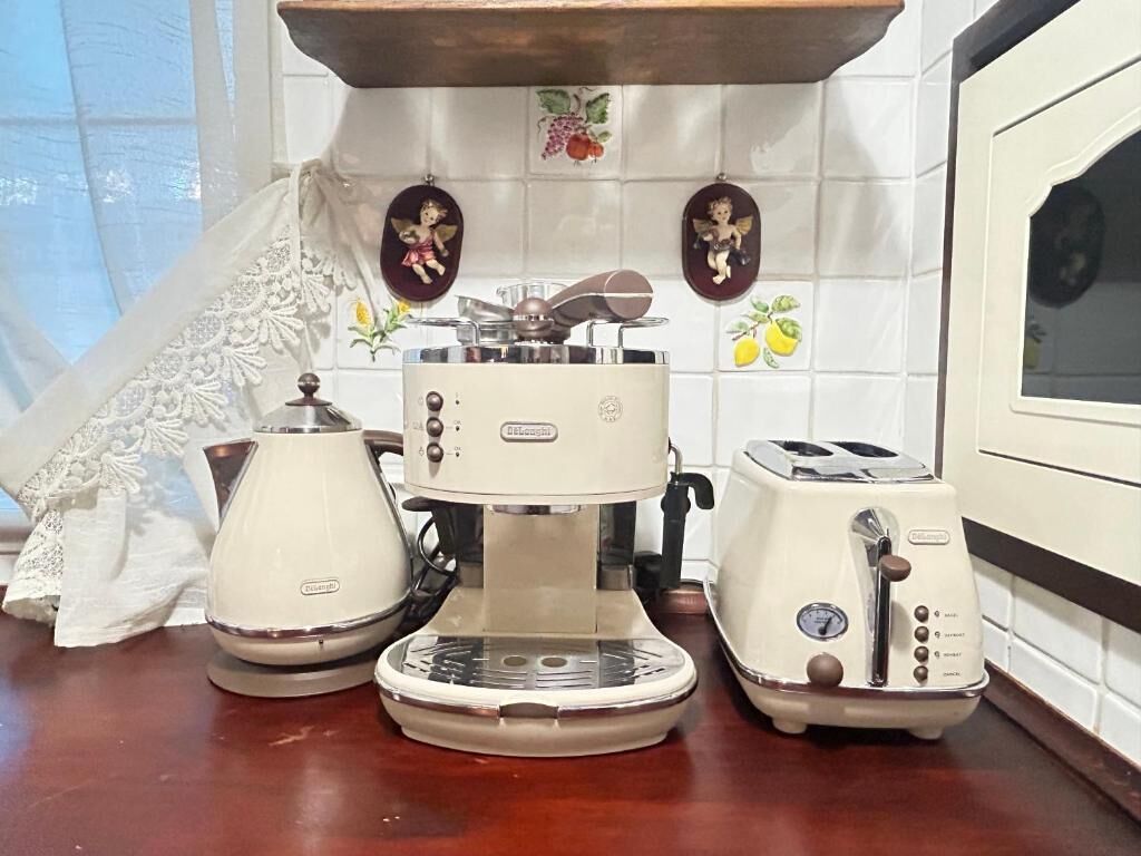 A kitchen with a coffee maker, toaster, and kettle on the counter.