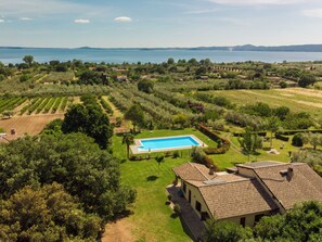 A villa with a swimming pool, surrounded by lush greenery and a view of the sea. - Rosa Alba by Interhome (Lago di Bolsena)