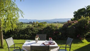 An outdoor dining table with chairs, set on a lawn with a view of a mountainous landscape. - Vecchio Mulino by Interhome (Chiusi)