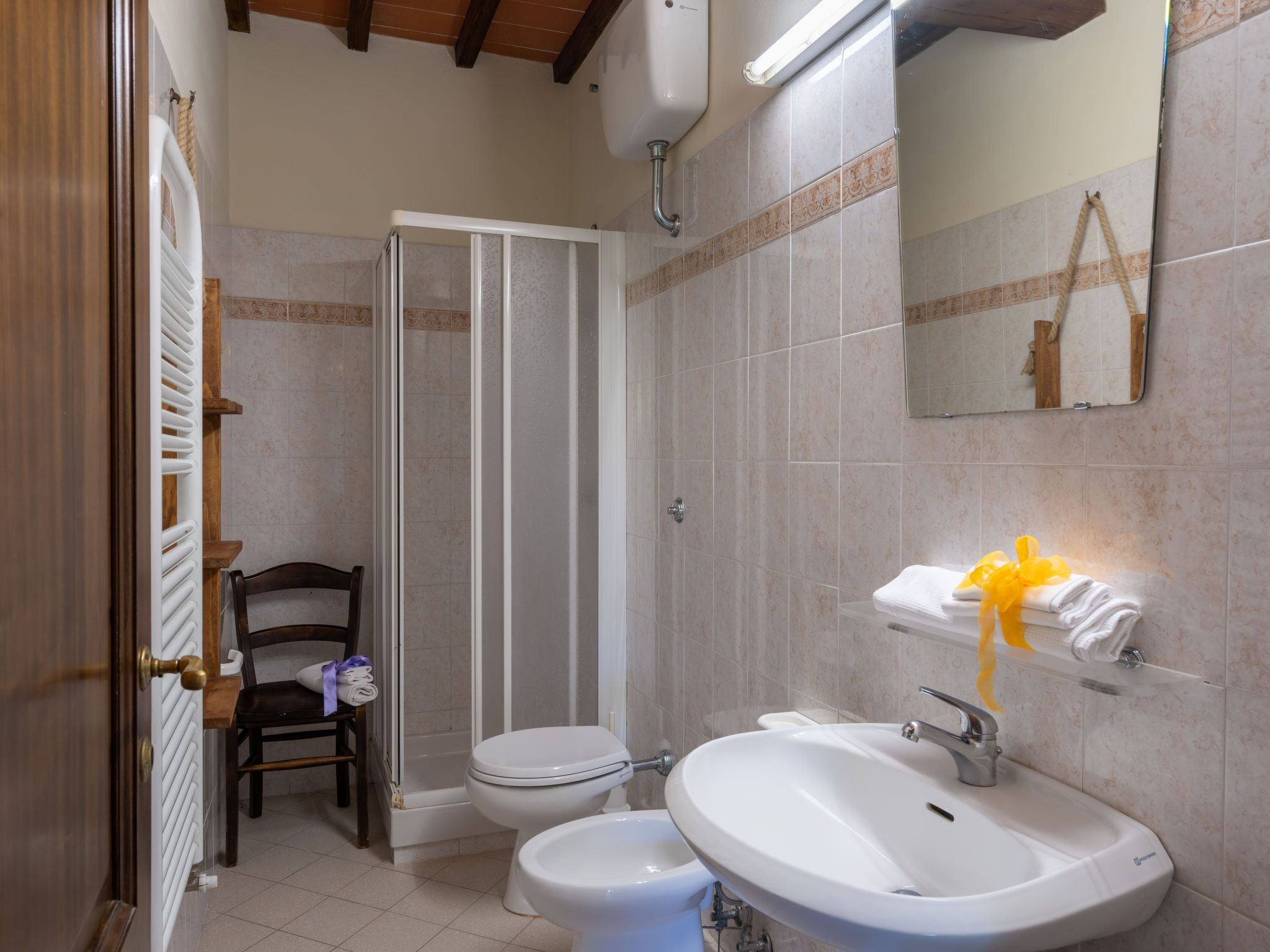 A bathroom with a shower, toilet, and sink.