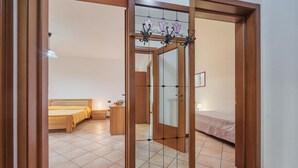 A bedroom with a bed, bedside table, and a mirror.