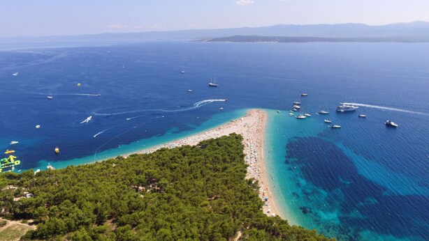 An aerial view of a coastal area with a beach, boats, and clear blue waters. - Vacation home Lucije by Interhome (Brač/Splitska)