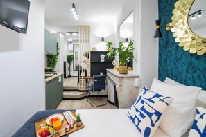 A modern hotel room with a bed, a breakfast tray, a desk, and a bathroom visible through a sliding door. - WS Opéra - Laffitte (Paris)