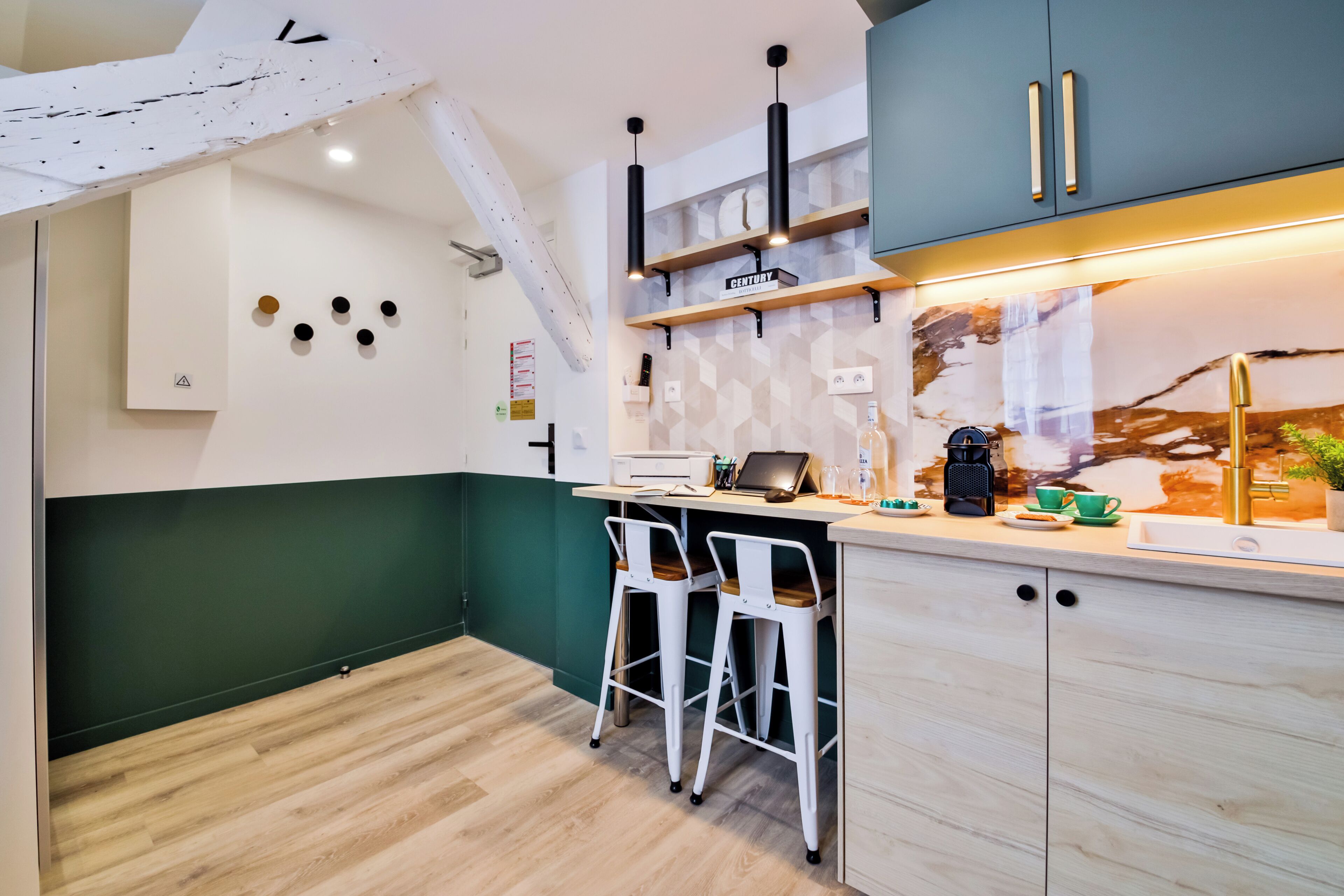 A modern kitchen with a wooden countertop, bar stools, and a built-in stove.