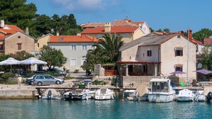 A coastal town with a marina, boats, and buildings with red-tiled roofs. - Vacation home Delfar by Interhome (Lošinj / Veli Lošinj)