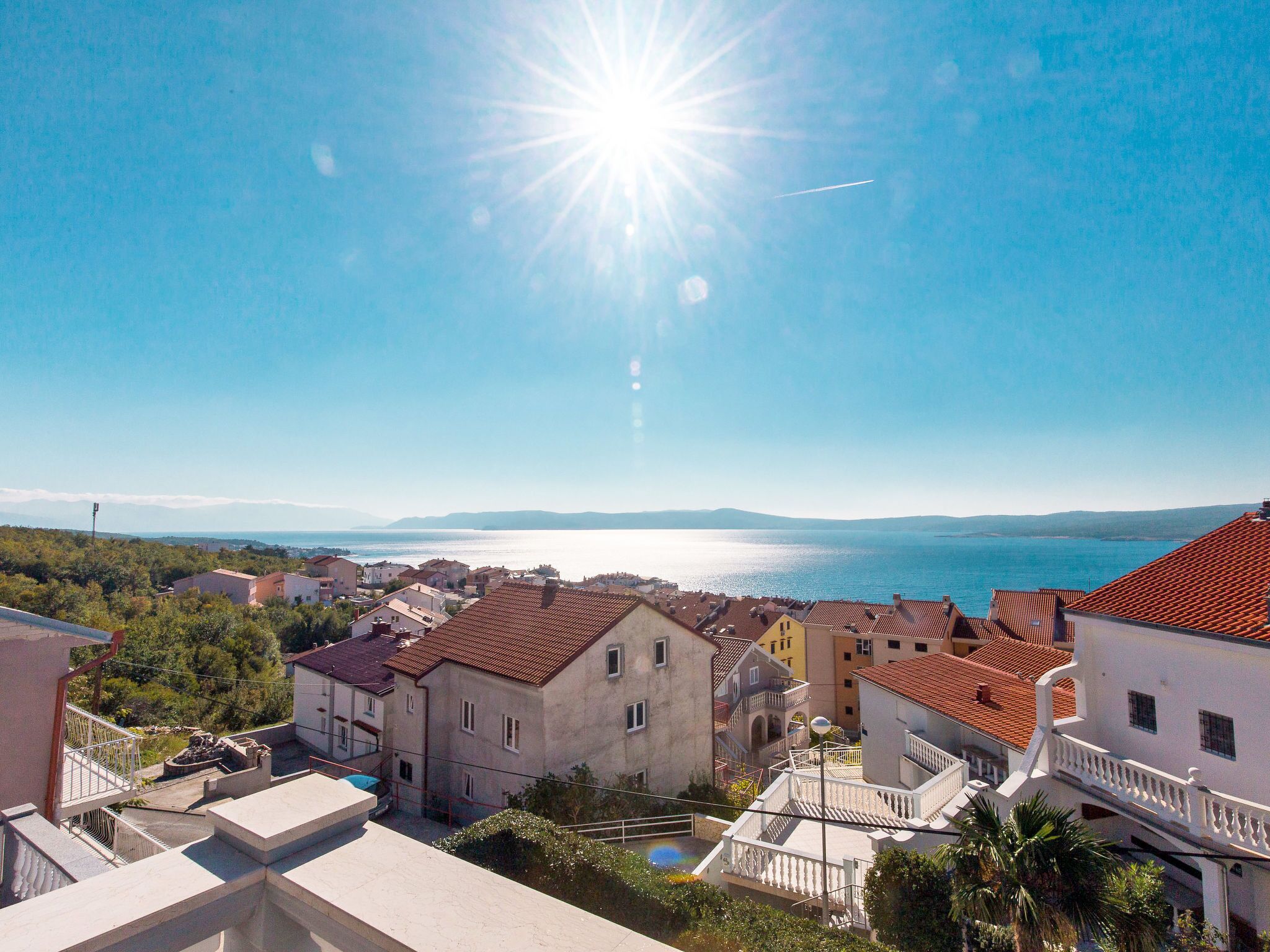 A coastal town with buildings and a clear view of the sea.