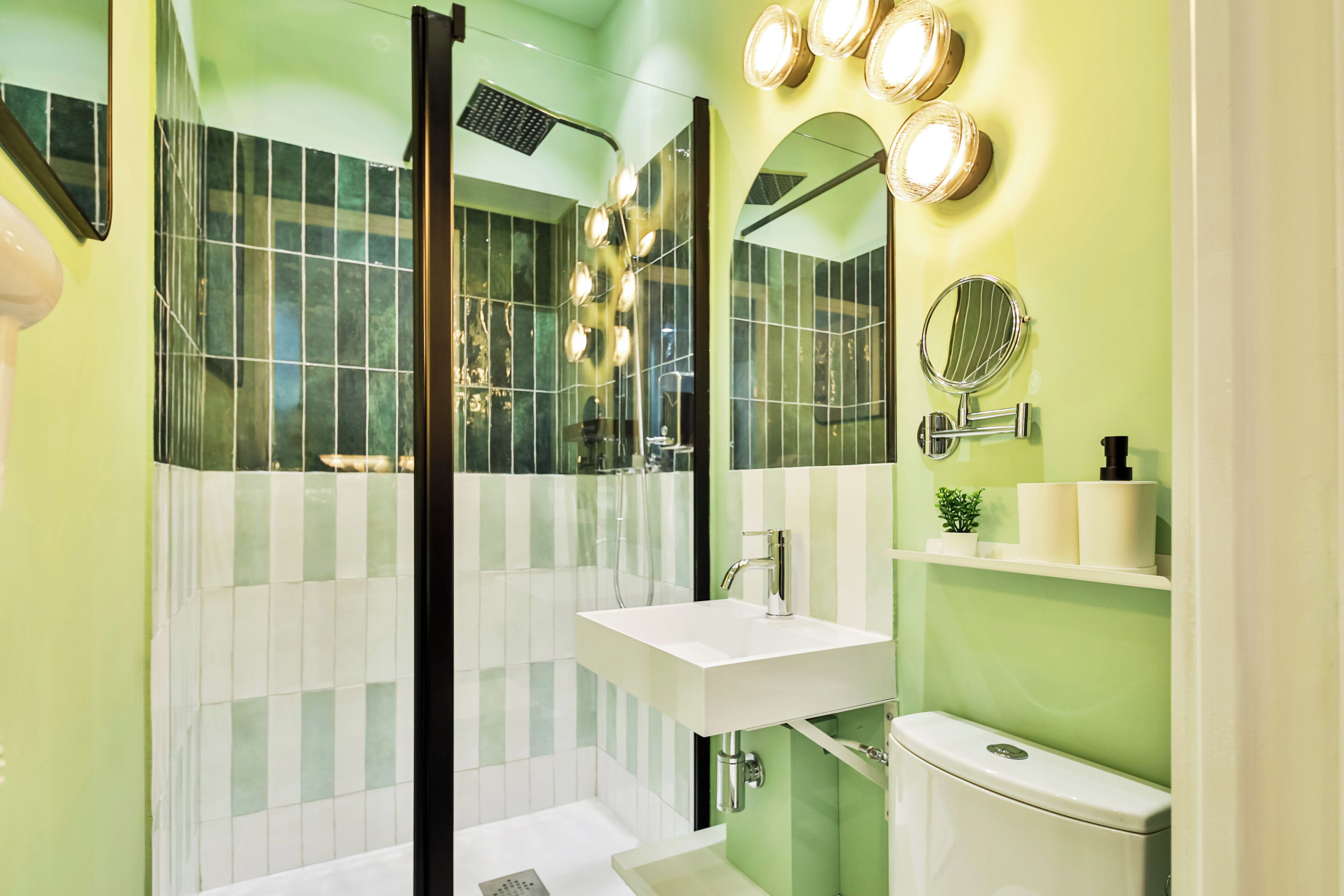 A bathroom with a shower, sink, and toilet.
