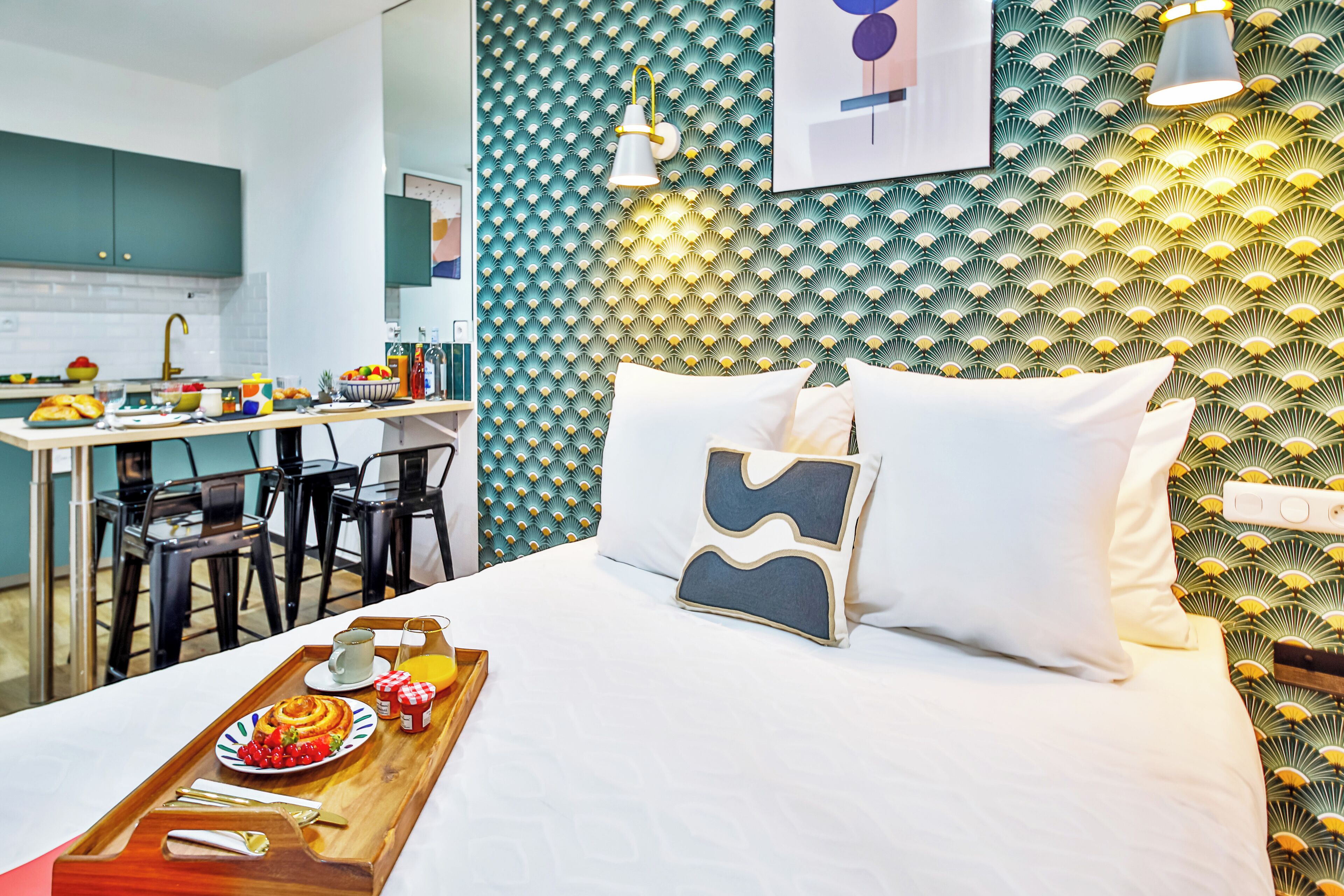 A modern hotel room with a bed, bedside table, and a breakfast tray.