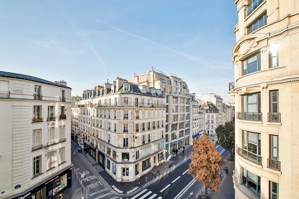 A multi-story building with a corner entrance, large windows, and a visible street view. - WS Hôtel de Ville - Beaubourg (Paris)