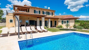 A two-story house with a swimming pool, outdoor seating, and a garden. - Baretuni by Interhome (Labin)