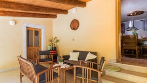 A cozy living area with wooden furniture, a sofa, and a coffee table. - Vacation home Mariva by Interhome (Pićan)