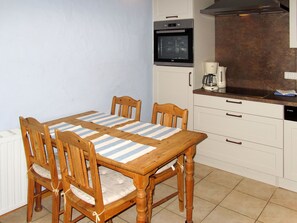 Enjoy meals with family and friends at the dining table for four, equipped with a dishwasher and oven.