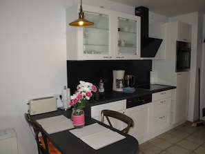 Enjoy cooking and dining in this well-equipped kitchen with an oven, microwave, and coffee maker.