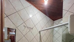A bathroom with a toilet, sink, and shower area. - Pousada Territorial  (Cairu)