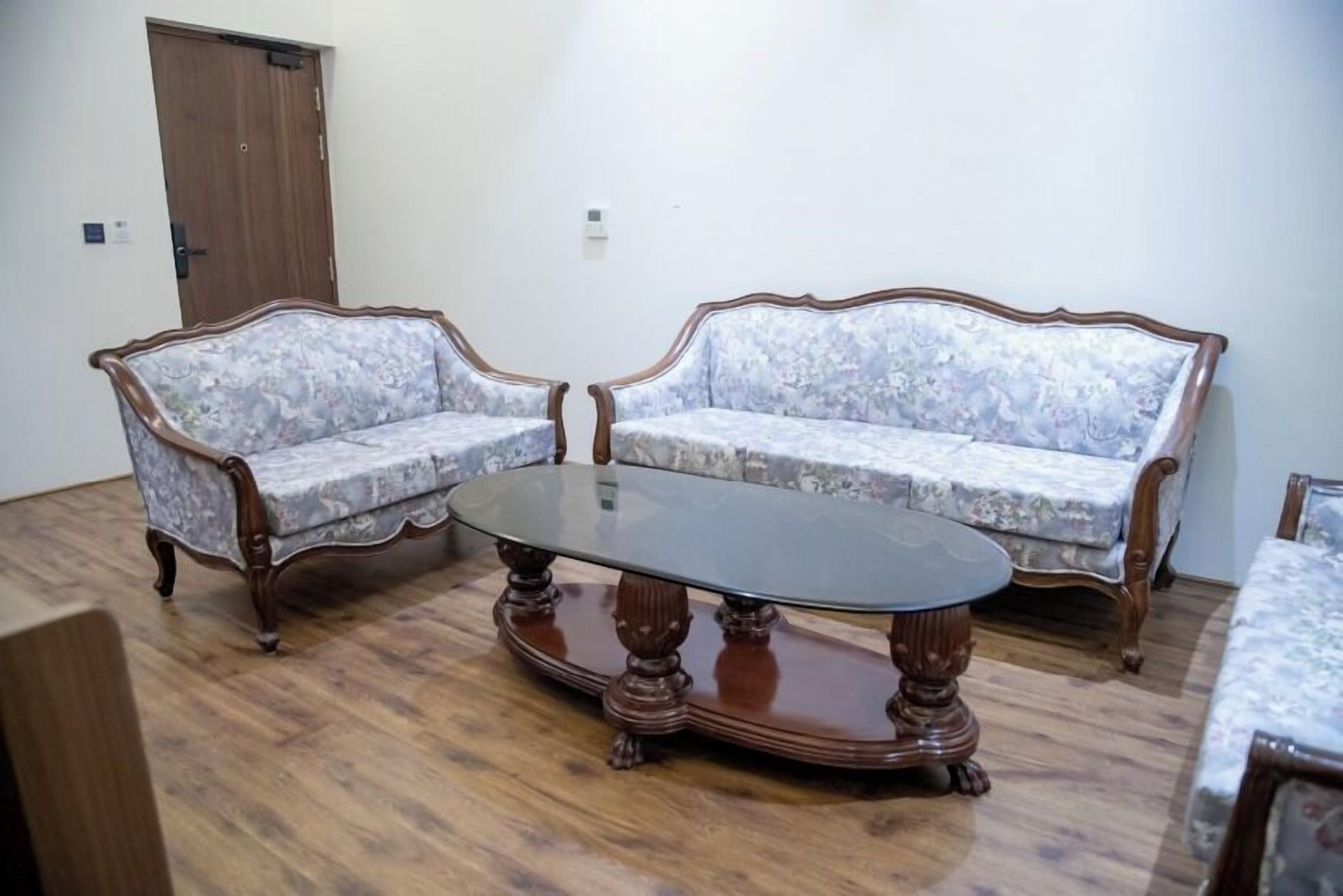 A room with two upholstered sofas and a wooden coffee table.