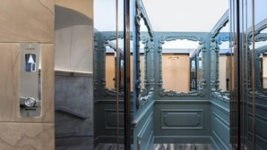 A bathroom with a marble floor, a toilet with a visible flush handle, and ornate metal railings. - Exquisite 2-Bedroom Luxury Apartment in Piazza della Signoria (Firenze)